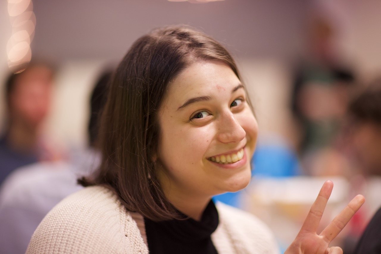 A white woman with shoulder-length brown hair and brown eyes.